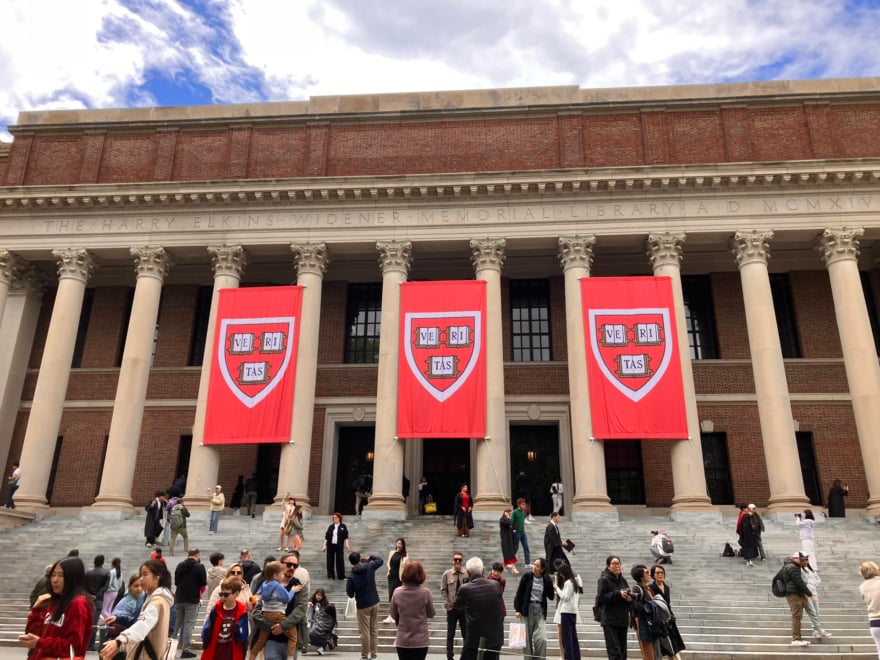 Les gens marchent devant la bibliothèque de l'Université Harvard ce lundi, à Boston